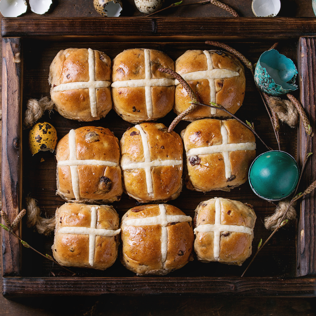 9 Hot cross buns all lined up in a tray