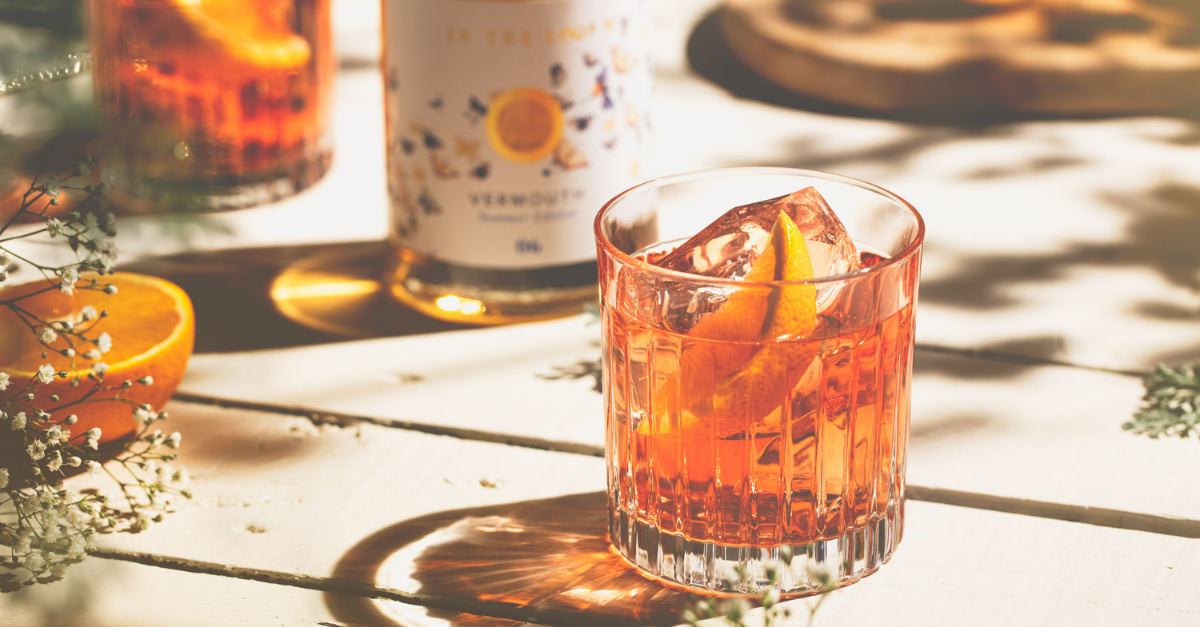 Negroni in cut glass tumbler garnished with fresh orange peel