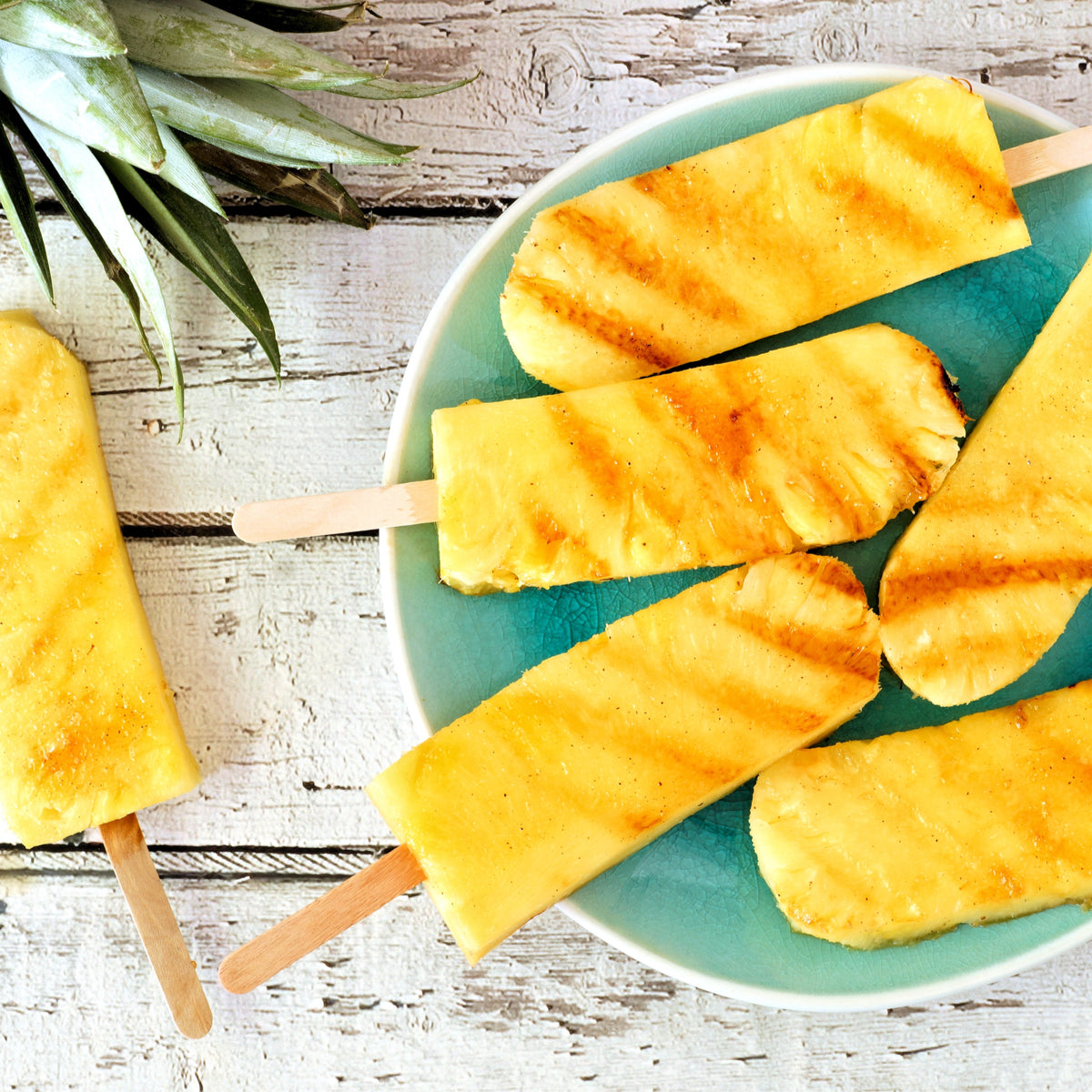 Chargrilled pineapple chunks on ice lolly sticks