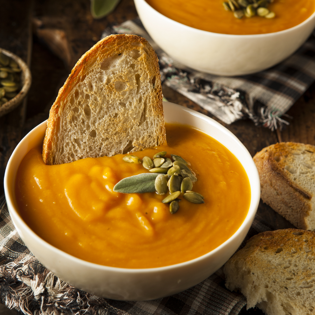 butternut squash soup garnished with seeds and toasted crusty bread