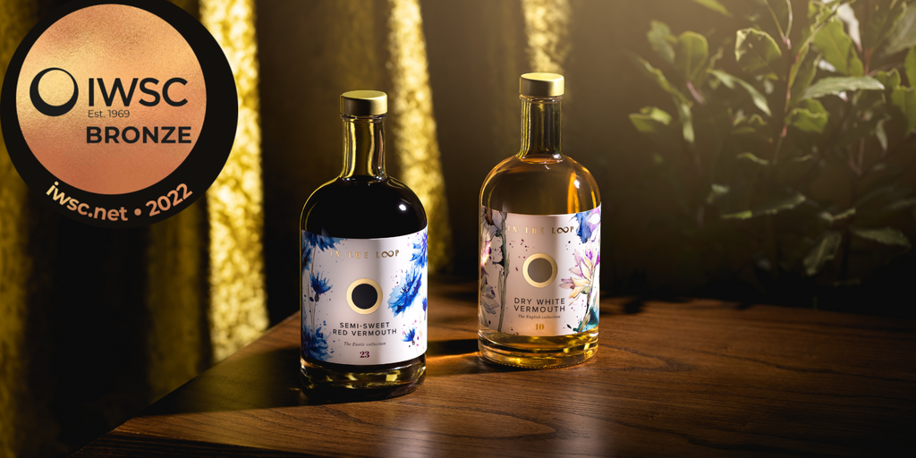 Semi-sweet red and dry white Vermouth in a moody setting with the IWSC bronze award medal in the corner